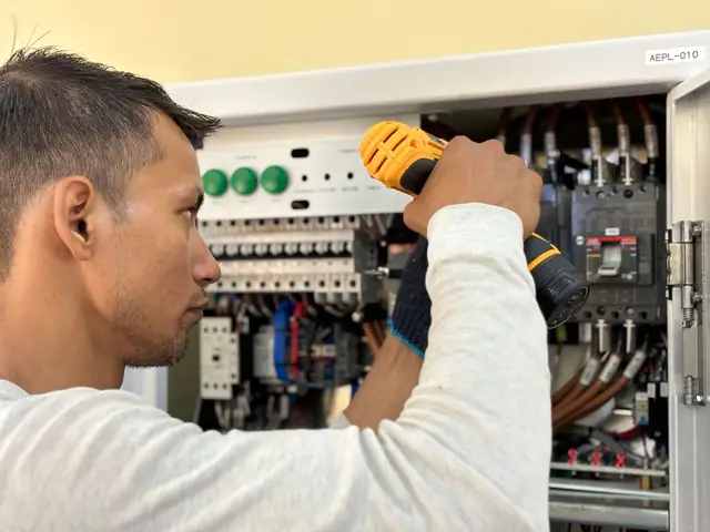 Electrician working on a breaker panel