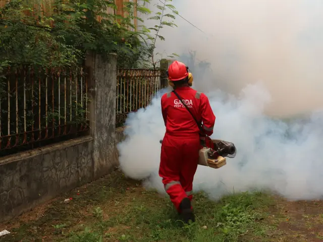 Pest control technician treating a yard