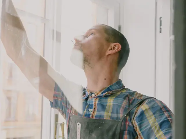 Installer fitting a new window